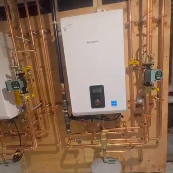 Wall hung boiler with copper manifold, circulators and expansion tank