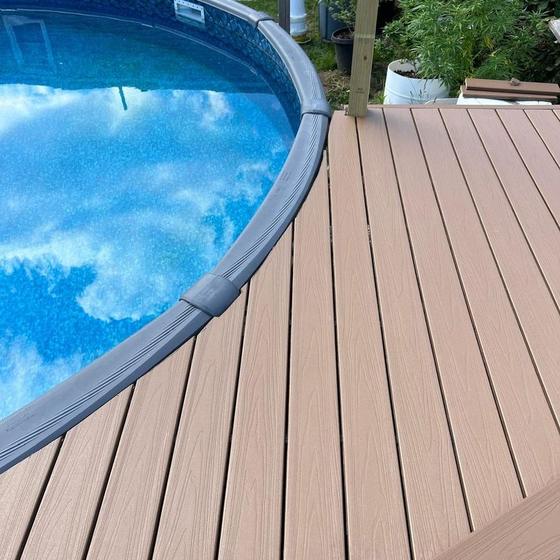 composite deck boards cut to follow the curve of the pool