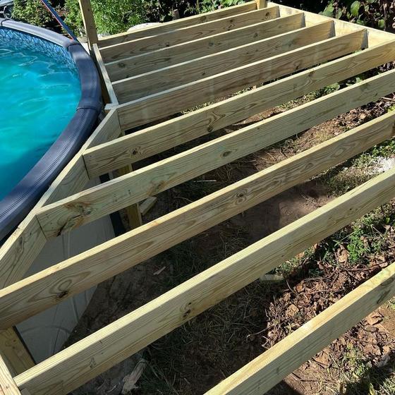 deck frame squared up and braced against the pool wall