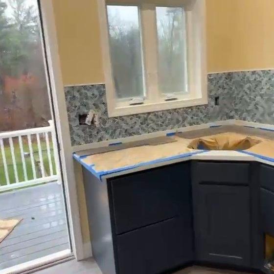Navy Shaker cabinets fitted, with the backsplash going in