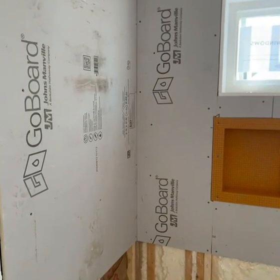 Waterproof board walls and a framed shower niche