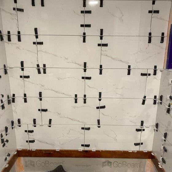 Tub surround tiled with large format panels